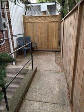 St. Catharines (Old Glenridge) apartment for rent - A wooden fence with a lattice top and a bench in front of it.