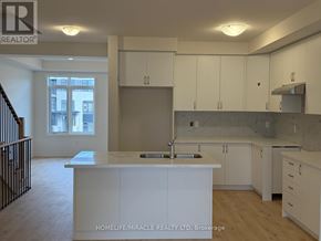 Oakville (Go Glenorchy) townhouse for rent - A kitchen with white cabinets and a countertop.