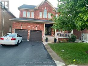 Brampton (Bram West) apartment for rent - A white car is parked in front of a brick house.