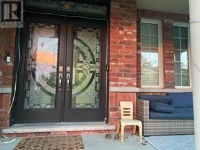 Brampton (Bram West) apartment for rent - A glass door with a circular glass window in the middle.