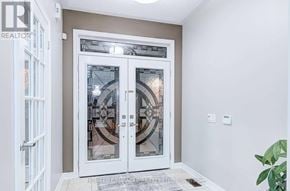 Brampton (Bram West) apartment for rent - A white door with a glass window and a metal handle.