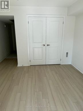 St. Catharines (Glendale/Glenridge) townhouse for rent - A white double door is in a room with wood flooring.
