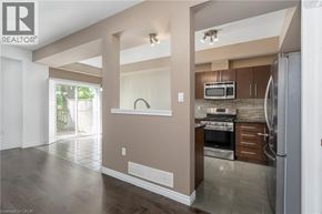 Ancaster townhouse for rent - A well-lit kitchen with a refrigerator, stove, and microwave.