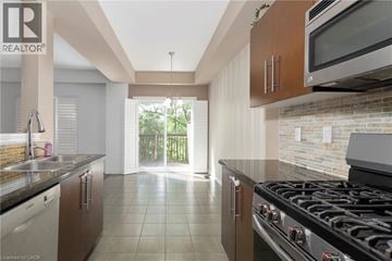 Ancaster townhouse for rent - A kitchen with a black stove top oven and a microwave above it.