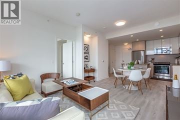 Burnaby apartment for rent - A modern living room with a white couch and a coffee table.