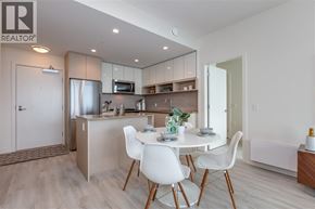 Burnaby apartment for rent - A modern kitchen with a dining table set for two.