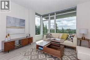Burnaby apartment for rent - A living room with a white couch, a coffee table, and a large window.