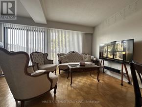 Toronto (Bayview Woods-Steeles) townhouse for rent - A living room with a couch, chairs, and a television.