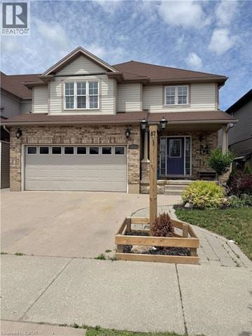 Kitchener apartment for rent - A house with a brown garage door and a brown roof.