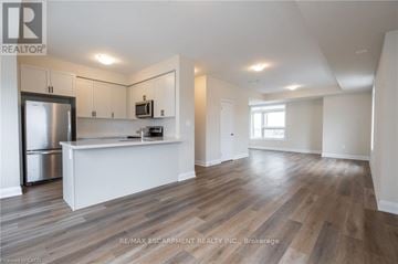 Milton (Cb Cobban) townhouse for rent - A kitchen with white cabinets and a wooden floor.