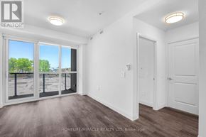 Kitchener condo for rent - A room with a large window and a sliding glass door.