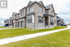 Cambridge apartment for rent - A large, modern house with a stone facade and a well-maintained lawn.