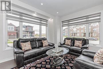 Cambridge apartment for rent - A living room with a black leather couch and a glass coffee table.