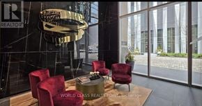 Toronto (Annex) condo for rent - A modern living room with a glass table and red chairs.