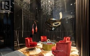 Toronto (Annex) condo for rent - A room with red chairs and a table with a cake on it.