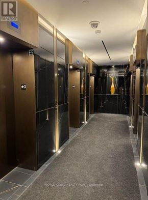 Toronto (Annex) condo for rent - A long hallway with elevators on both sides.