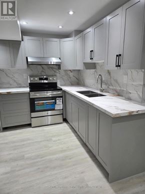 Whitchurch-Stouffville (Stouffville) apartment for rent - A modern kitchen with a marble backsplash and stainless steel appliances.
