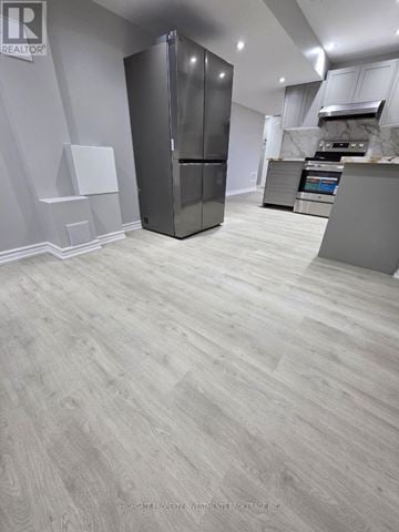 Whitchurch-Stouffville (Stouffville) apartment for rent - A kitchen with a refrigerator and a countertop.