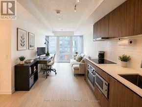 Toronto (Church-Yonge Corridor) condo for rent - A well-lit kitchen and living room with modern appliances and furniture.