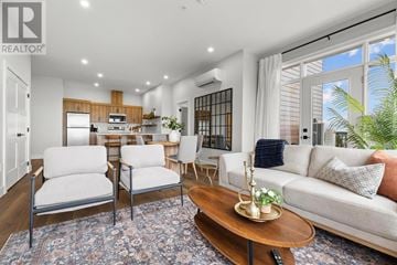 Charlottetown condo for rent - A well-lit, modern living room with a wooden coffee table and a white sofa.