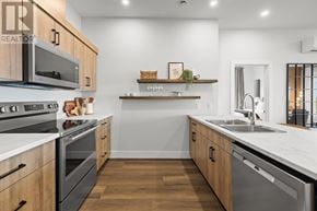 Charlottetown condo for rent - A modern kitchen with wooden cabinets and stainless steel appliances.