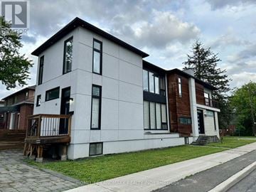 Toronto (Newtonbrook East) apartment for rent - A modern two-story house with a white exterior and a balcony on the first floor.