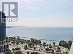 Toronto (High Park-Swansea) condo for rent - A realtor logo is superimposed on a scenic view of a coastal area.