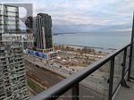 Toronto (High Park-Swansea) condo for rent - A cityscape with a body of water in the background.