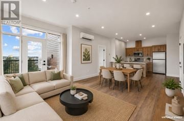 Charlottetown condo for rent - A modern living room with a large window, a white sofa, and a dining area with a wooden table and chairs.