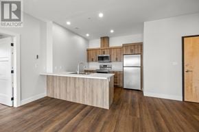Charlottetown condo for rent - A modern kitchen with wooden floors and a center island.