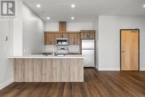 Charlottetown condo for rent - A modern kitchen with wooden cabinets and a white countertop.
