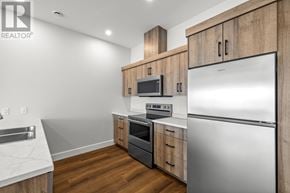 Charlottetown condo for rent - A modern kitchen with wooden cabinets and stainless steel appliances.