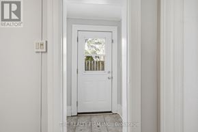 London South (South F) fourplex for rent - A white door with a window in the middle of it.