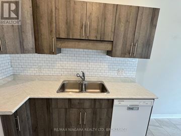 Welland (West Welland) townhouse for rent - A kitchen with a sink and a dishwasher under a cabinet.