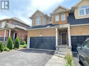 Oakville (Wm Westmount) apartment for rent - A large house with a garage and a car parked in front.