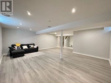 Oakville (Wm Westmount) apartment for rent - A spacious living room with a black couch and grey flooring.