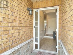 Oakville (Wm Westmount) apartment for rent - A brick wall with a doorway leading to another room.