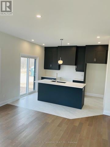 Niagara Falls (Marineland) apartment for rent - A modern kitchen with dark cabinets and a white countertop.
