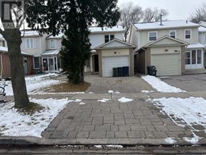 Toronto (Milliken) apartment for rent - A brick walkway leads to a garage in front of a house.