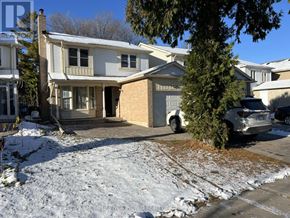 Toronto (Milliken) apartment for rent - A house with a white garage door and a brown brick chimney.