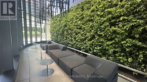 Toronto (Waterfront Communities) condo for rent - A real estate office with a green wall.