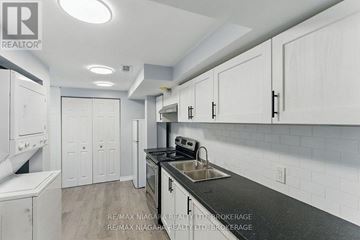 Welland (Lincoln/Crowland) apartment for rent - A kitchen with white cabinets and a black countertop.