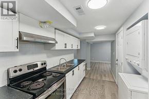 Welland (Lincoln/Crowland) apartment for rent - A kitchen with white cabinets and a stove top oven.