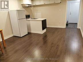 Toronto (Newtonbrook West) apartment for rent - A kitchen with white appliances and wooden floors.