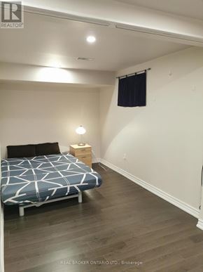 Toronto (Newtonbrook West) apartment for rent - A bedroom with a bed, nightstand, and window.