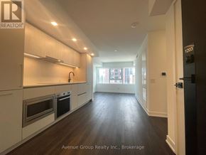 Toronto (North St. James Town) condo for rent - A kitchen with white cabinets and stainless steel appliances.