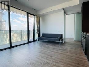 Toronto (Church-Yonge Corridor) condo for rent - A living room with a couch and sliding glass doors.
