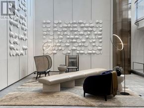 Toronto (Waterfront Communities) condo for rent - A modern living room with a white wall art and a bench.