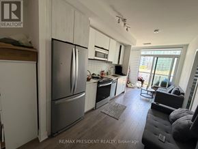 Toronto (Bendale) condo for rent - A kitchen with a refrigerator, microwave, and oven.