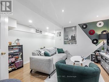 Toronto (East End-Danforth) apartment for rent - A living room with a grey couch and a green armchair.